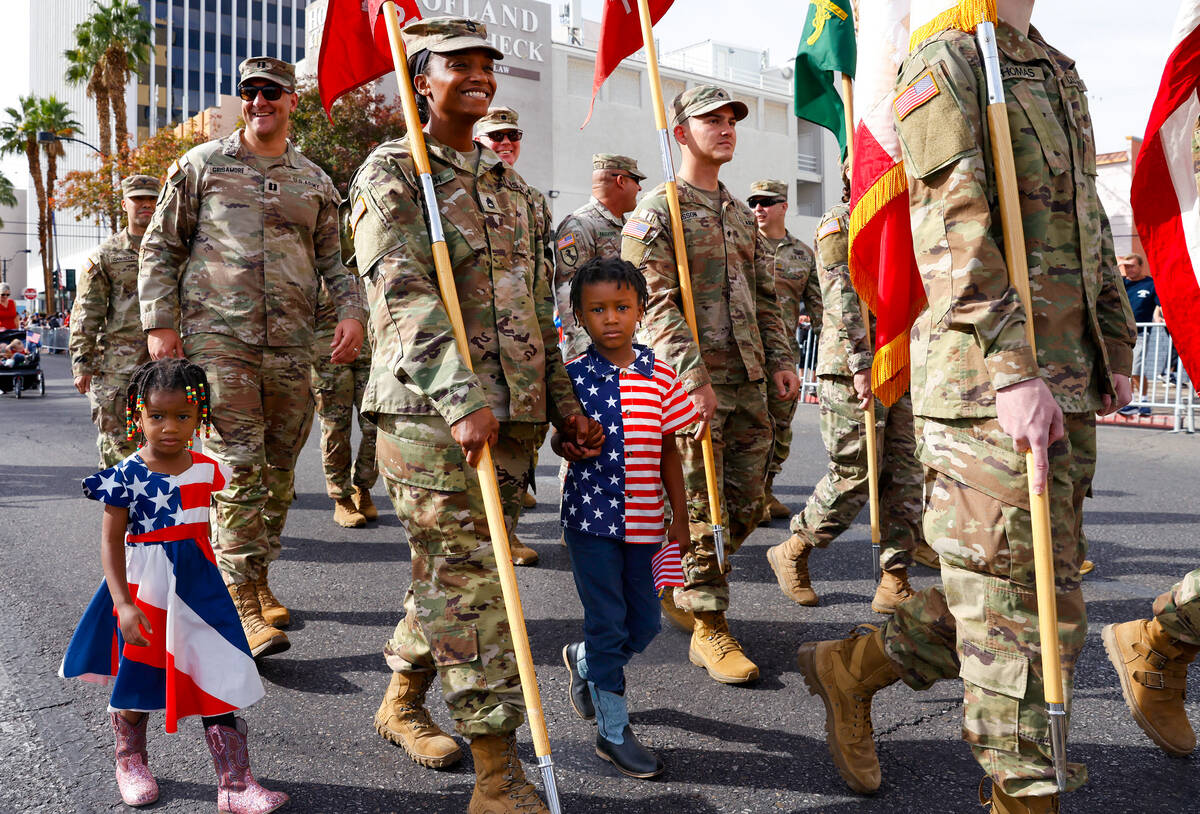 Aerial Lynch, 3, left, and her brother Titus, 5, participate in the Annual Veterans Day Parade ...