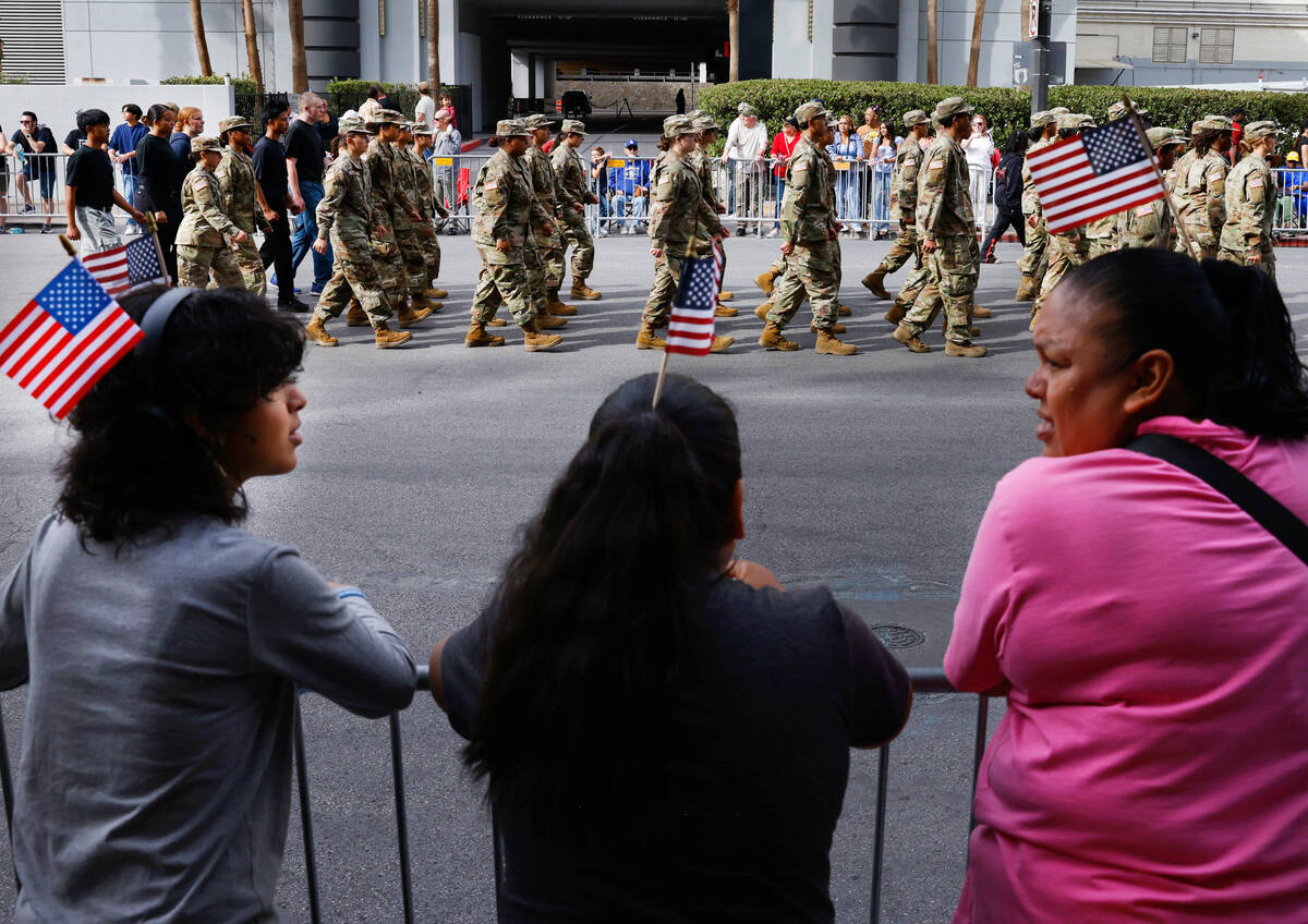 People watch as members of the Shadow Ridge High School Air Force Corps JROTC participate in th ...