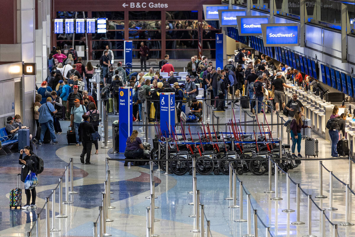Passengers line up at the ticket counter for Southwest Airlines as the FAA has reduced flights ...
