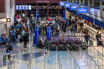 Passengers line up at the ticket counter for Southwest Airlines as the FAA has reduced flights ...