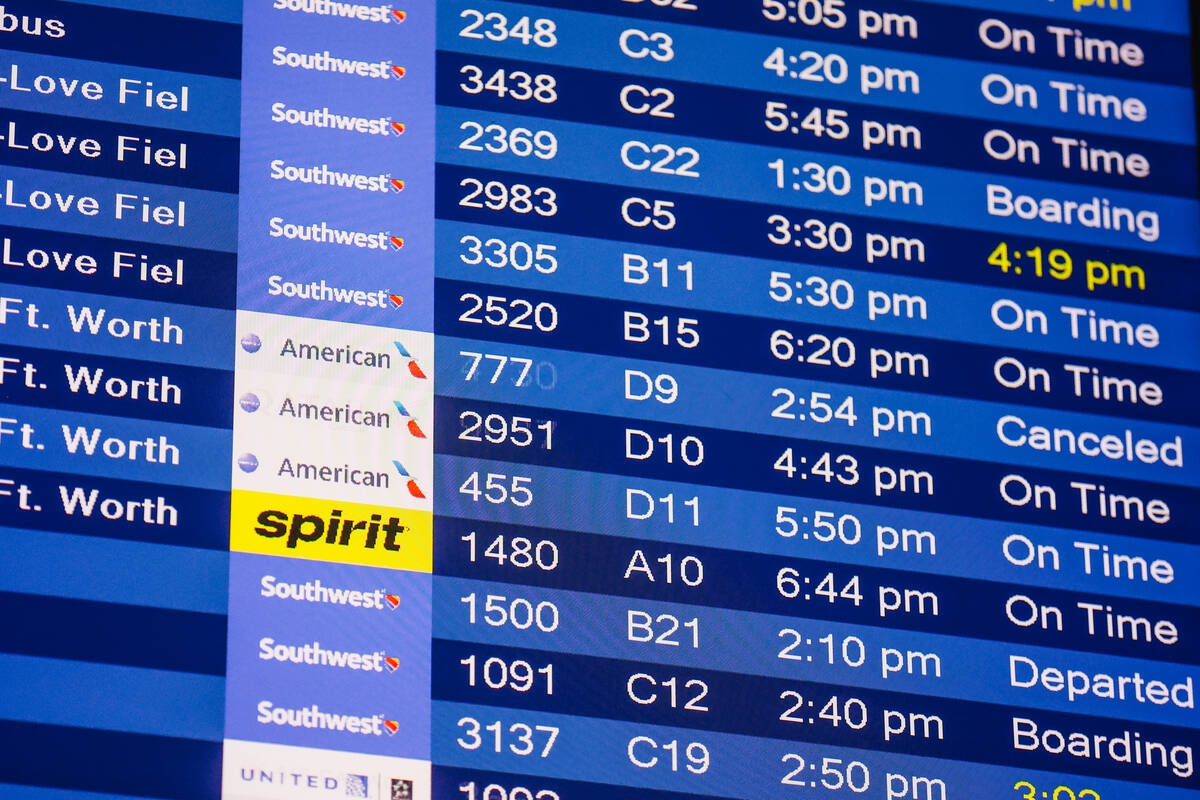 Flights are listen on a board at Harry Reid International Airport Sunday, Nov. 9, 2025, in Las ...