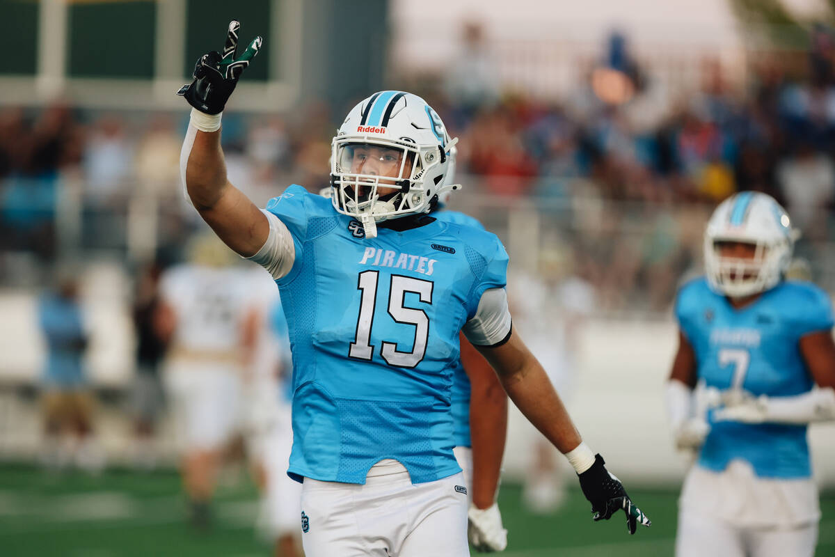 Sloan Canyon’s Gavin Rhodes (15) celebrates an interception during a high school footbal ...