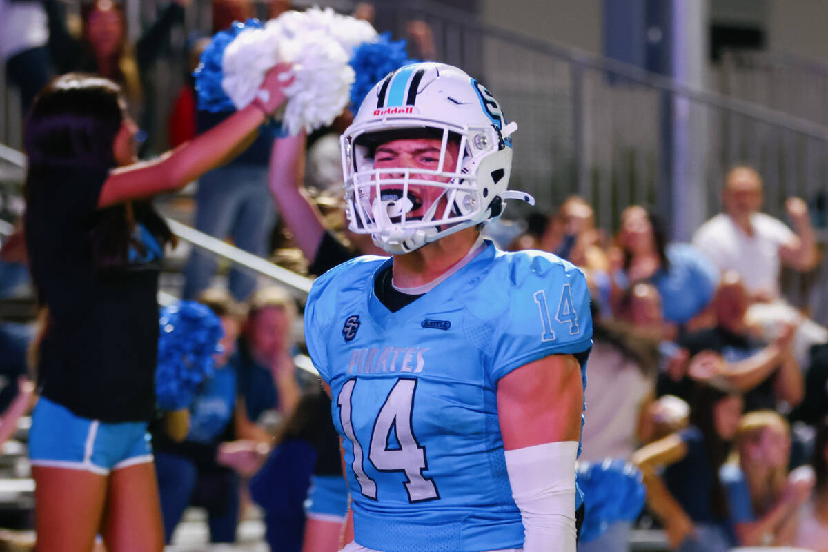 Sloan Canyon Christian Rhodes (14) celebrates running in a touchdown during the game on Friday, ...