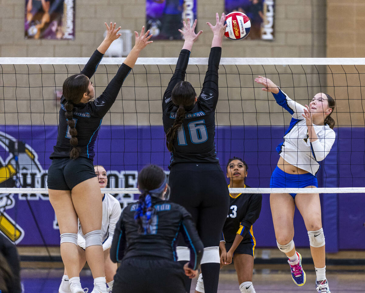 Sierra Vista's Presley Hartstrom (7) smashes the ball attempting to pass Silverado's ...