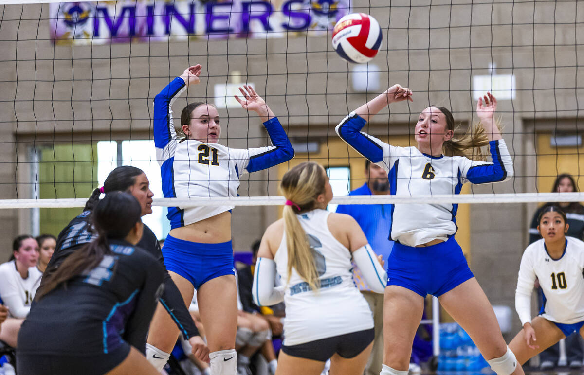 Sierra Vista's Lyla Sneek (21) and Sienna Rhein (6) eye a ball blocked back to Silverado&# ...