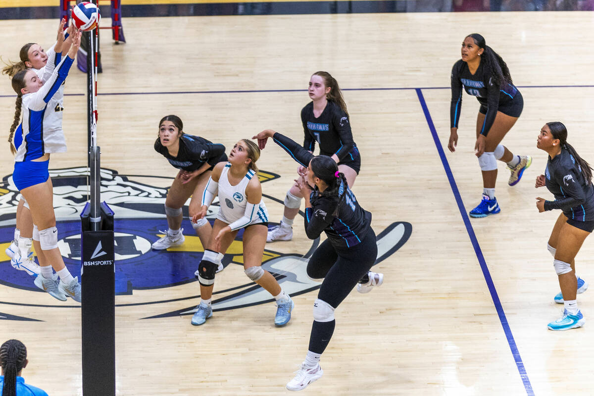 Sierra Vista's Lyla Sneek (21) and Sienna Rhein (6) block a spike by Silverado's Kali ...