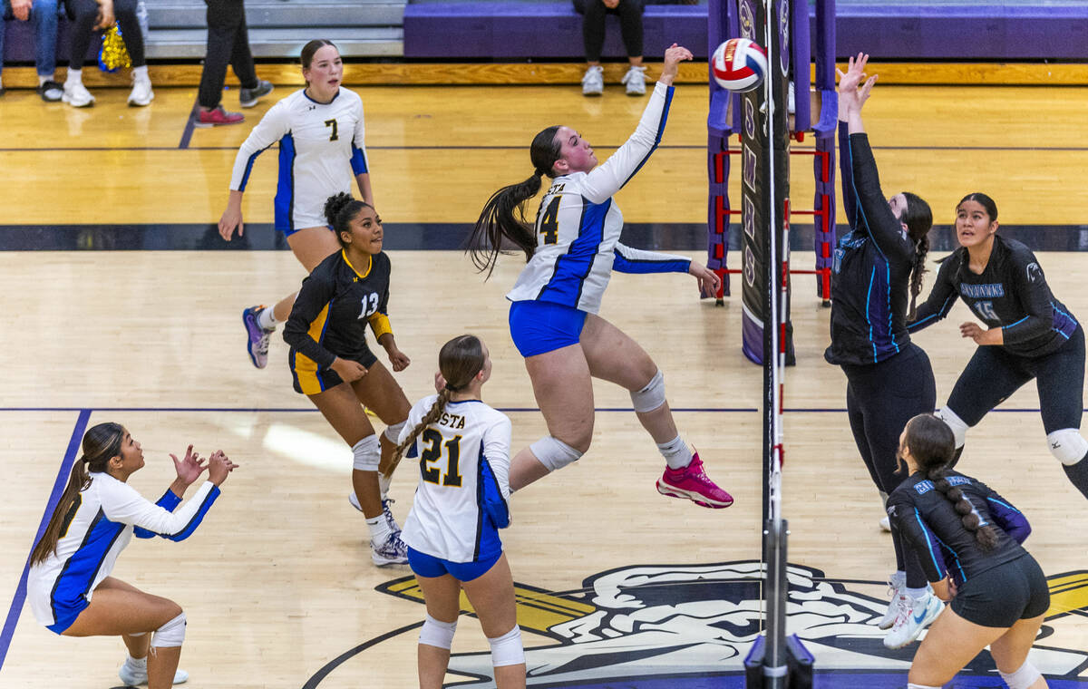 Sierra Vista's Kenna Key (14) connects with a spike as Silverado's Madison Smith (16) ...