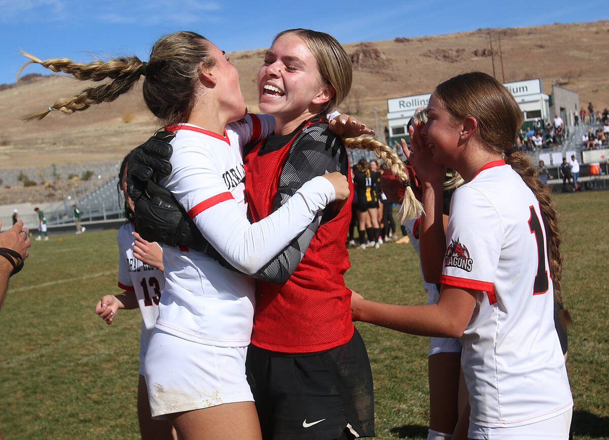 Doral Academy Red Rock’s Kenadie Mashore, middle, and Gianna Davis, left, celebrate after def ...