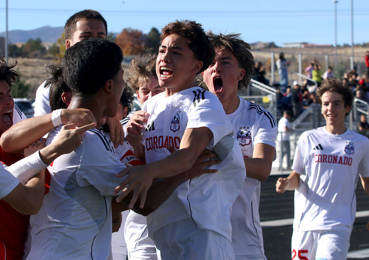 Coronado players celebrate after defeating Hug 2-1 to win the NIAA 5A state championship soccer ...