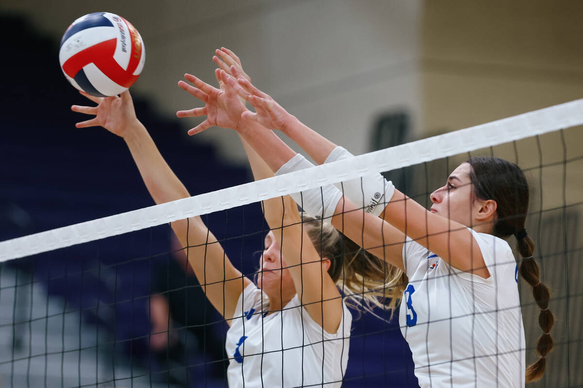 Bishop Gorman middle blocker Ellie Prindl (7) and outside hitter Boyana Pesic (3) block a hit f ...