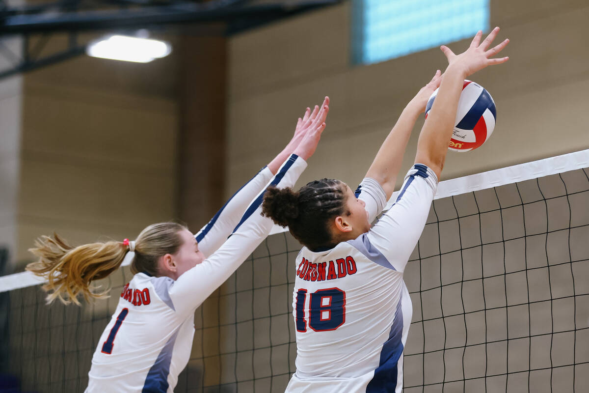 Coronado middle blocker Hannah Wayment (1) and opposite Olivia Allen (18) block a hit from Bish ...