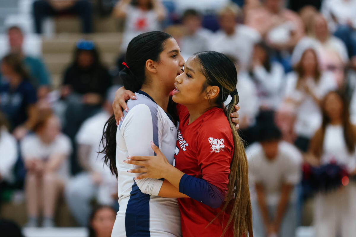 Coronado setter Alyssa Leone (8) and libero Isabelle Guerzon (5) embrace and strategize between ...