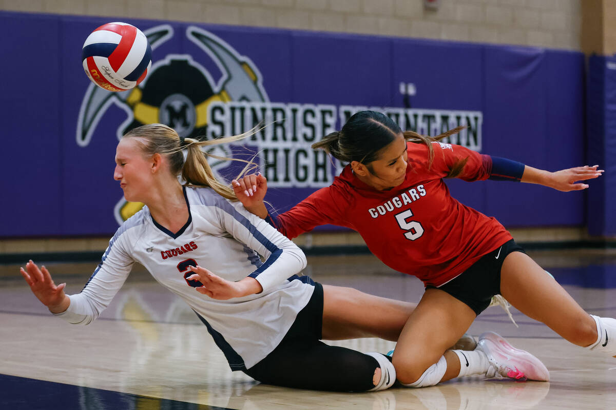 Coronado outside hitter Julie Beckham (2) and libero Isabelle Guerzon (5) collide while diving ...