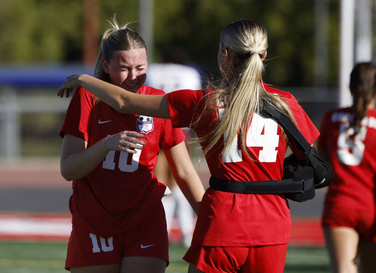 Coronado's midfielder Ryan Neel (10) is comforted by Allison Kleiner (14) after loosing to ...
