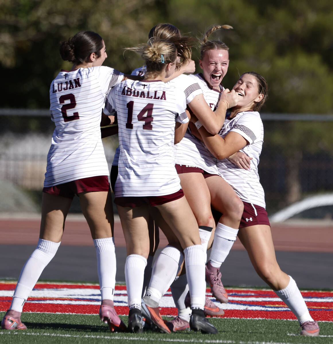 Faith Lutheran's striker Julia Anfinson, second right, celebrates with her teammates after ...