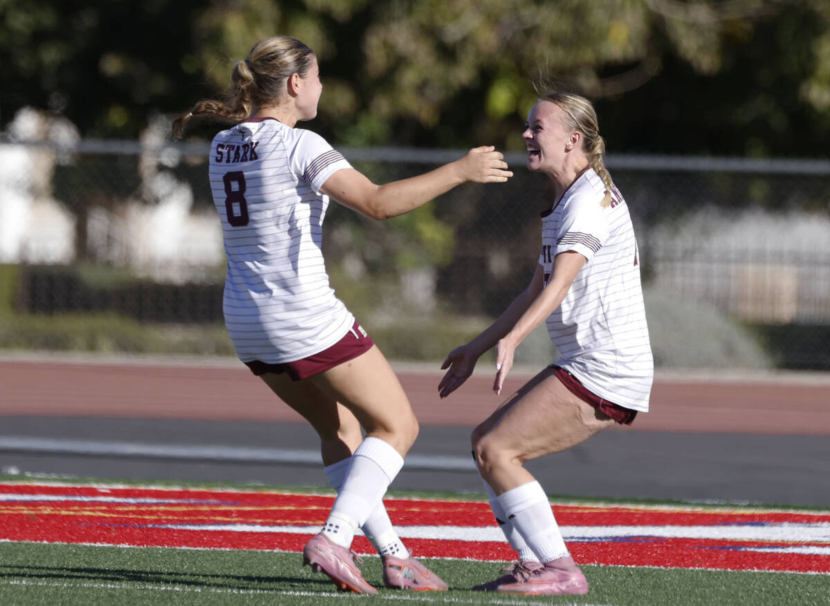 Faith Lutheran's striker Julia Anfinson, right, celebrates with her teammate Olivia Stark ...