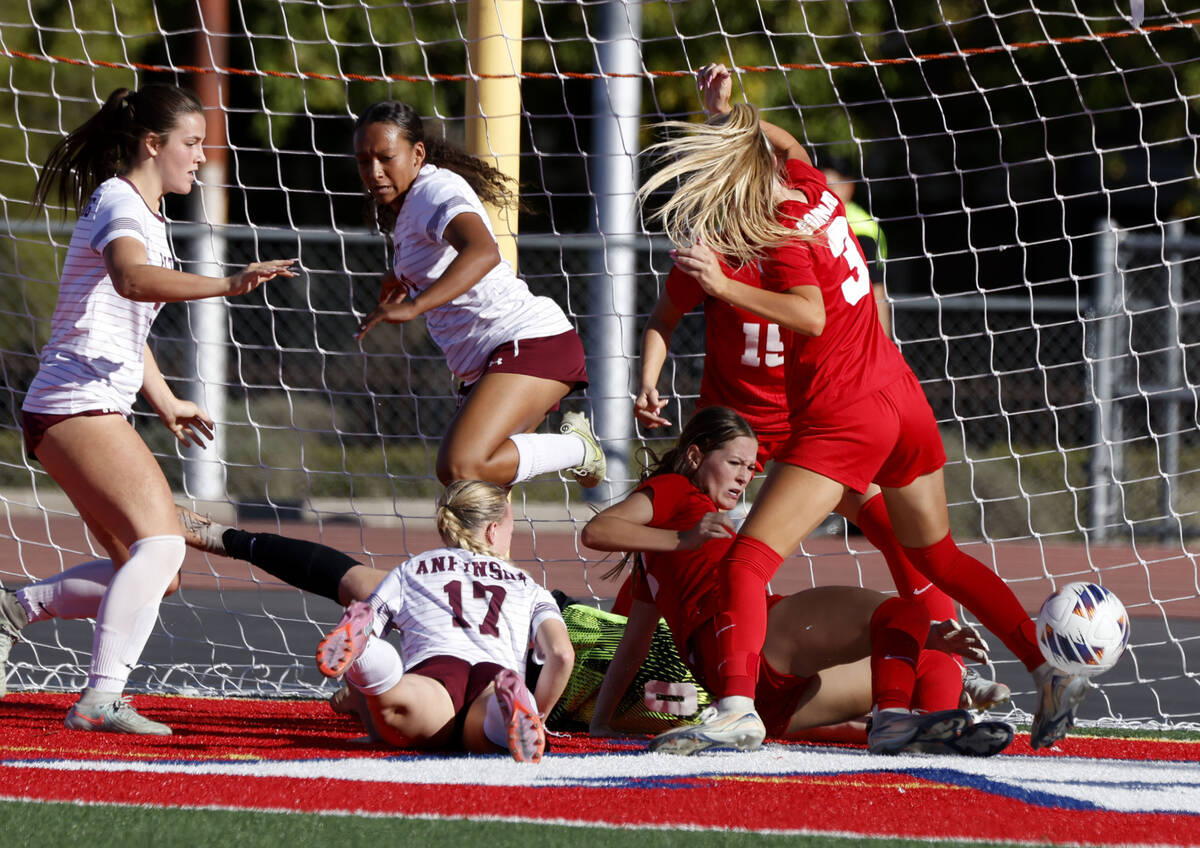 Coronado's goalkeeper Lilian Foss (0) deflects a ball kicked by Faith Lutheran's stri ...