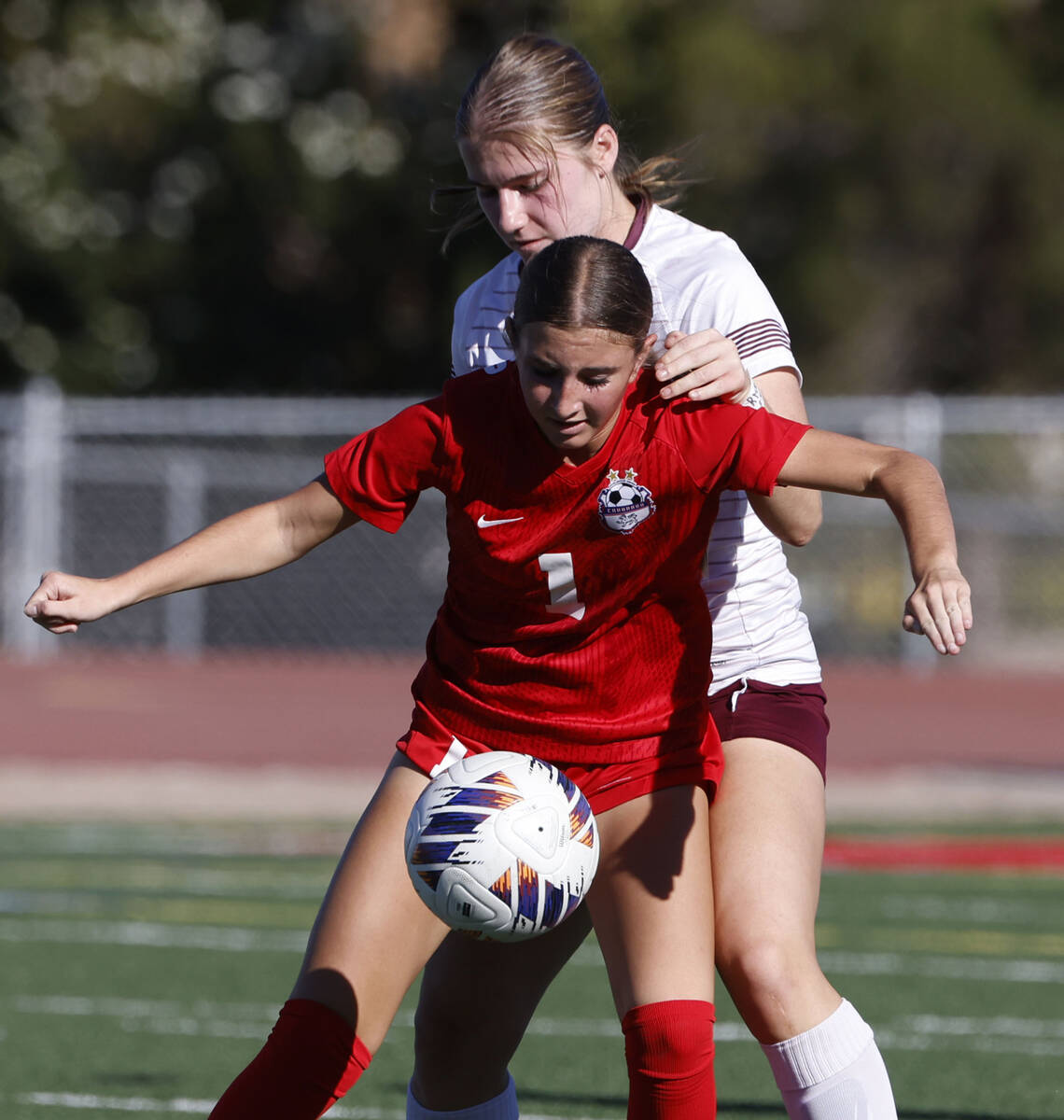 Coronado's midfielder Taytum Arens (1) protects the ball from Faith Lutheran's defens ...