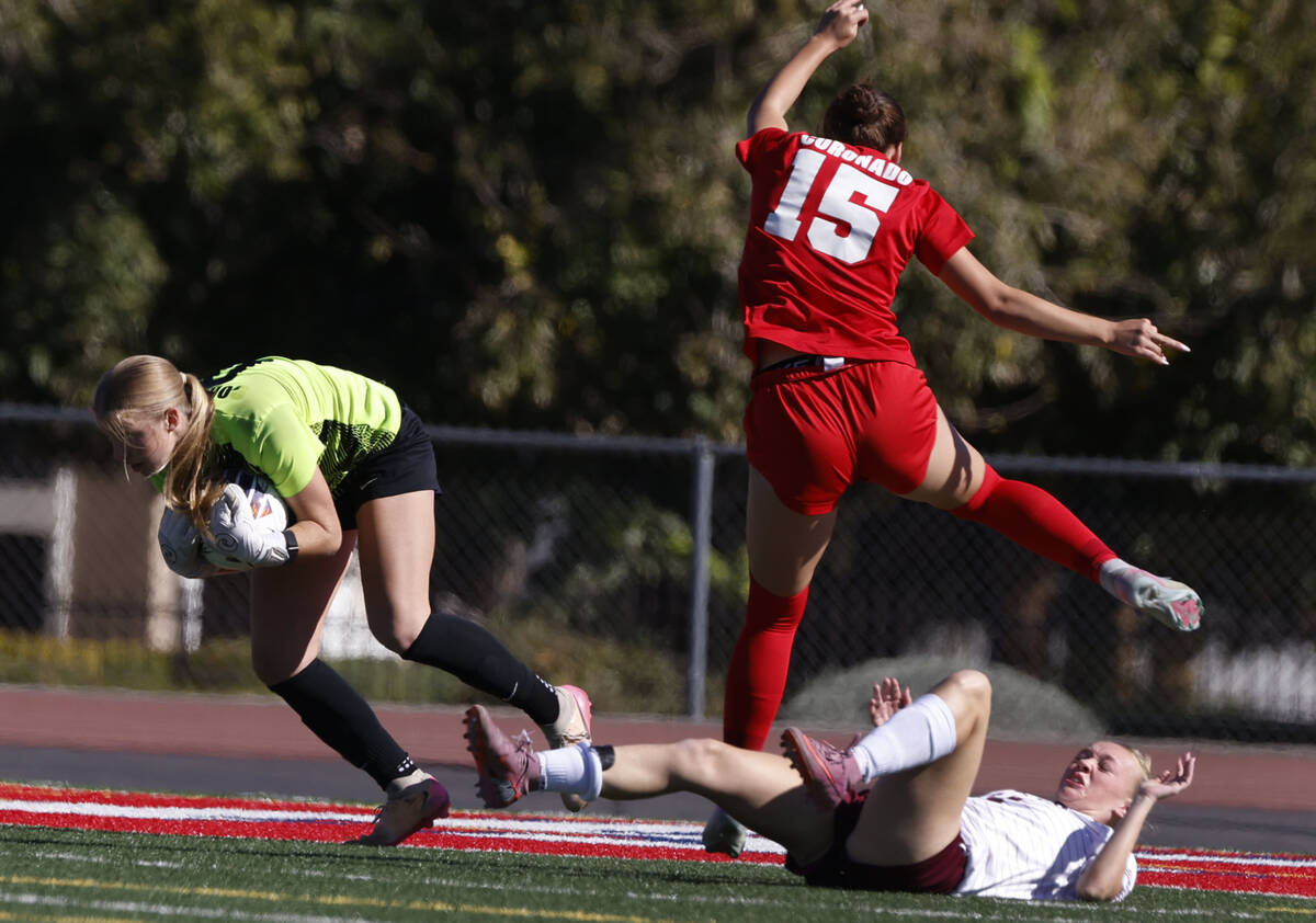 Coronado's goalkeeper Lilian Foss (0) stops the ball as Faith Lutheran's striker Jul ...