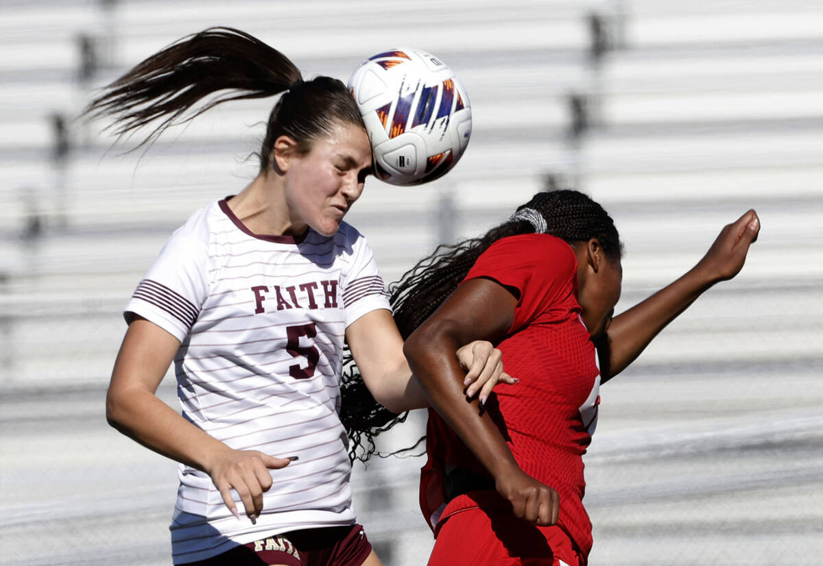 Faith Lutheran's defense Posie Armstrong (5) goes for a header against Coronado's for ...