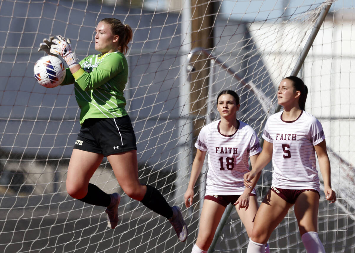 Faith Lutheran's goalkeeper Olivia Petty (99) stops the ball as defense Addison Jarvis (18 ...