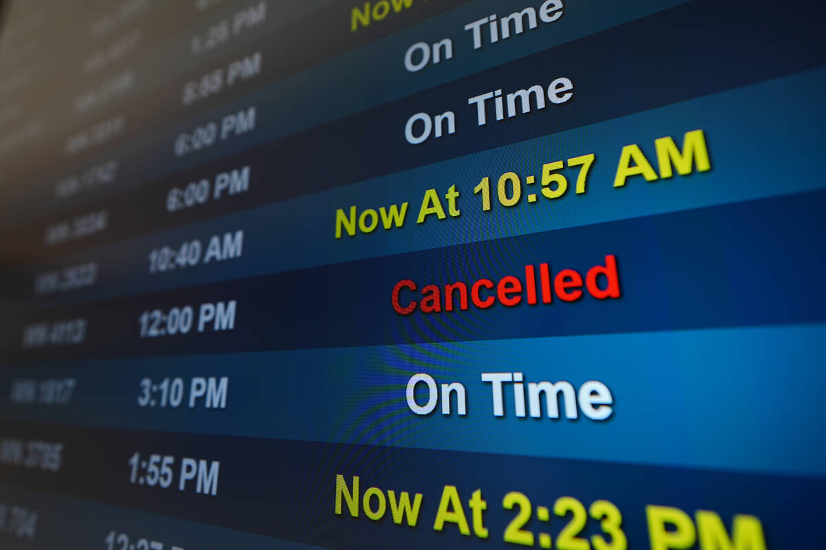 A flight is listed as cancelled on a display at San Diego International Airport Saturday, Nov. ...