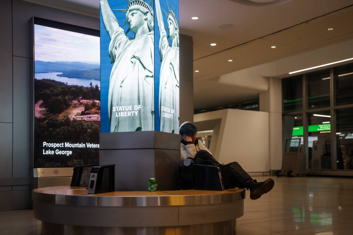 A traveler sleeps at Laguardia International Terminal on Saturday, Nov. 8, 2025, in New York. ( ...