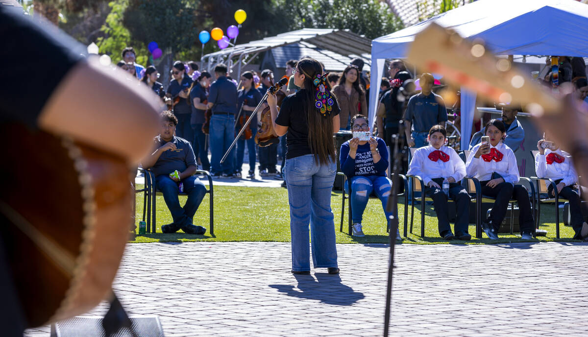 Performers with the student mariachi group from Canyon Springs High School entertain the crowd ...