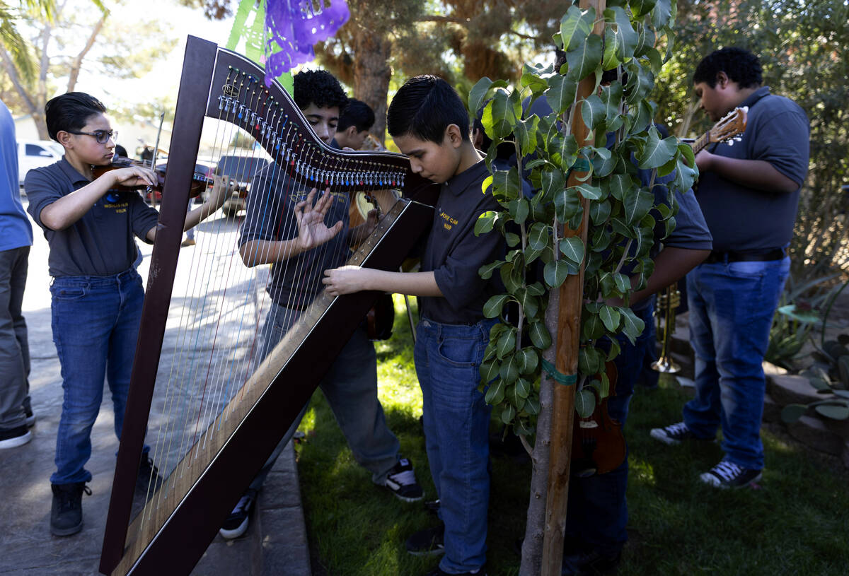 Musicians with the student mariachi group from Keller Middle School warm up on the lawn before ...