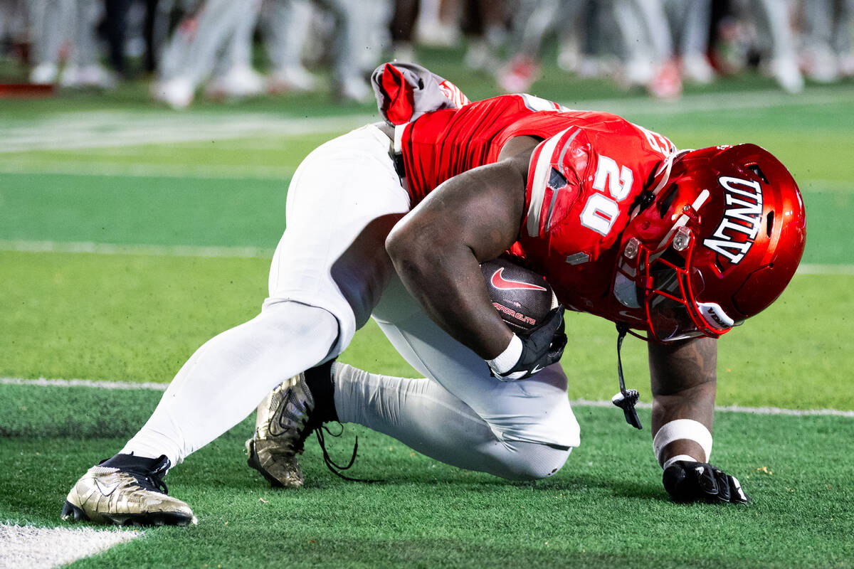UNLV running back Jaylon Glover (20) rolls into the end zone for a touchdown against the Colora ...