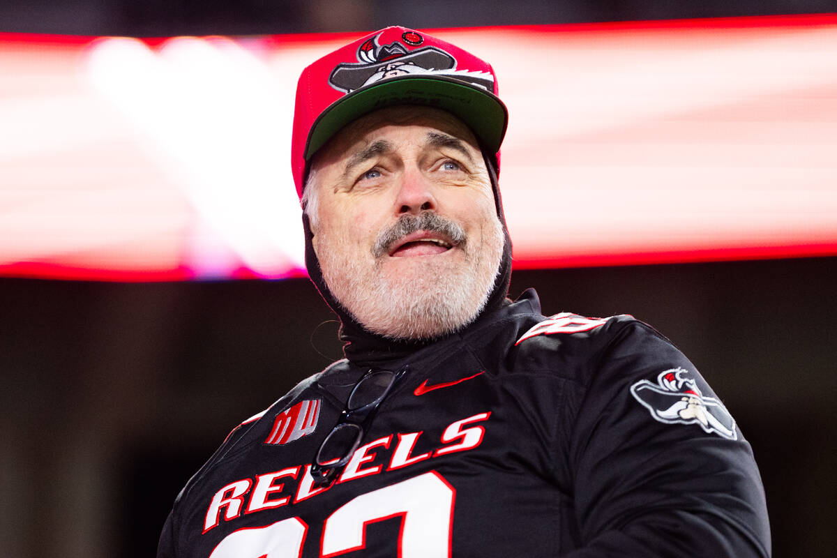 UNLV fan watches the game during the second half of their NCAA football game against the Colora ...