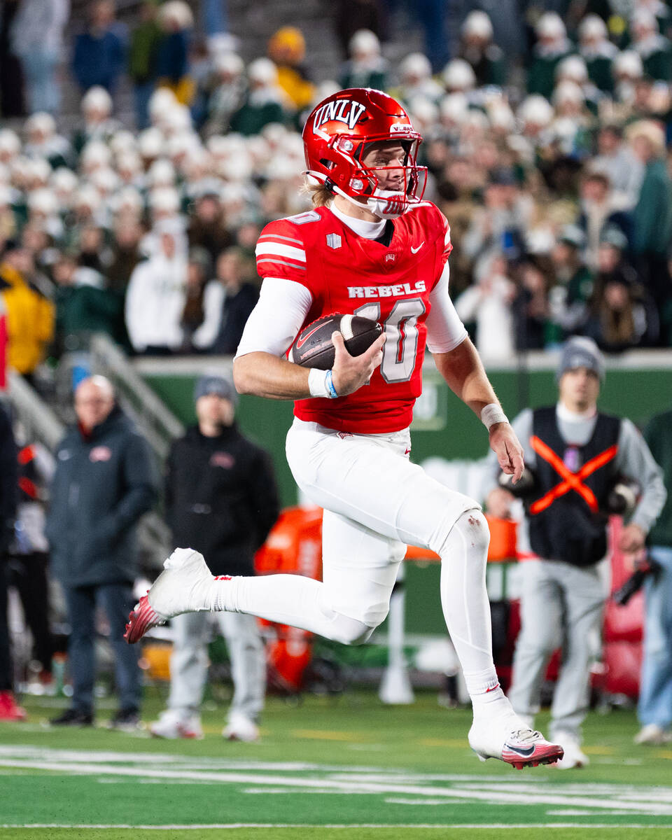 UNLV quarterback Anthony Colandrea (10) leaps into the end zone for a touchdown against the Col ...