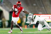 UNLV running back Keyvone Lee (2) attempts to stiff arm Colorado State Rams linebacker Jett Vin ...