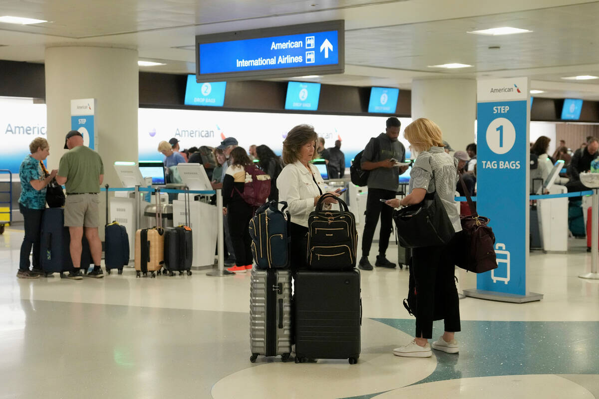 Passengers check in at the American Airlines ticket counter at Phoenix Sky Harbor International ...