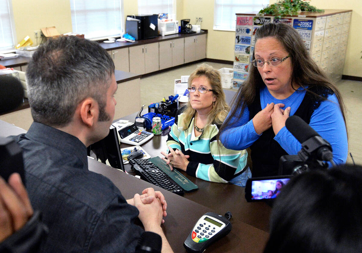 Rowan County Clerk Kim Davis, right, talks with David Moore following her office's refusal to i ...