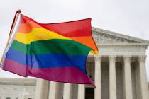 Supporters of the LGBT wave their flag in front of the U.S. Supreme Cour, Oct. 8, 2019, in Wash ...