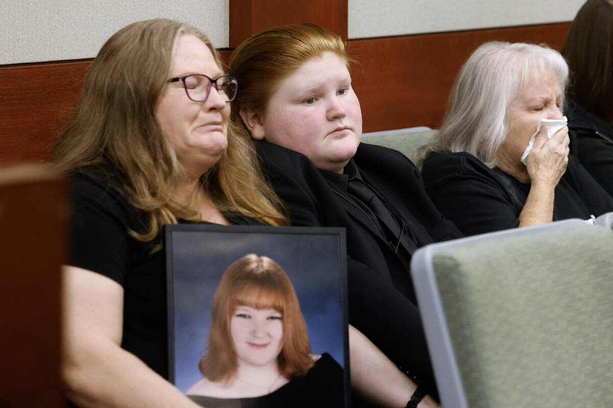 Tiffany Reynolds, left, holding a photograph of her daughter McKenzie Scott, her son Kasen, 12, ...