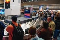 Travelers wait for baggage at Harry Reid International Airport Sunday, Nov. 9, 2025, in Las Veg ...