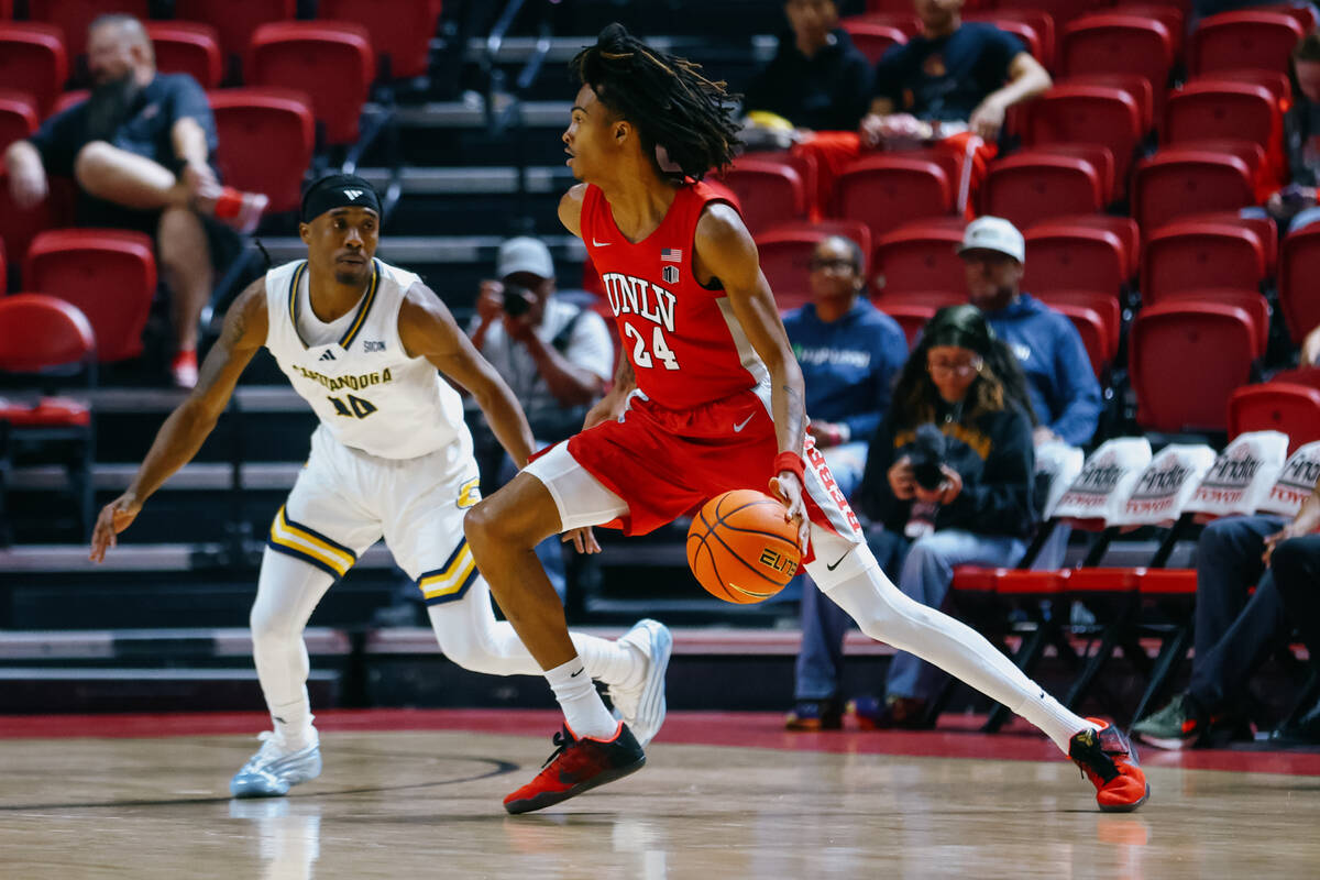 UNLV forward Naas Cunningham (24) dribbles around Chattanooga guard Teddy Washington Jr. (10) d ...