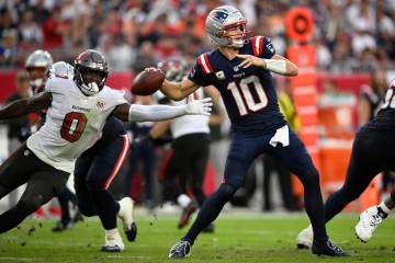 New England Patriots quarterback Drake Maye (10) throws a pass in front of Tampa Bay Buccaneers ...