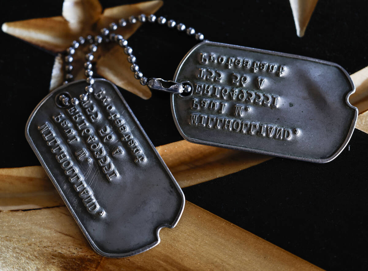 U.S. Army veteran Paul Millholland’s dog tags are photographed at family friend and fell ...