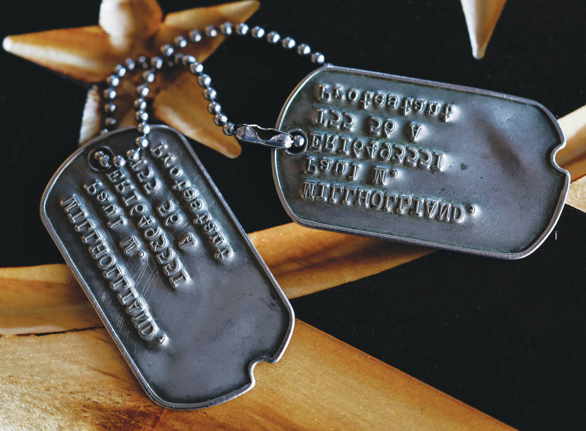 U.S. Army veteran Paul Millholland’s dog tags are photographed at family friend and fell ...