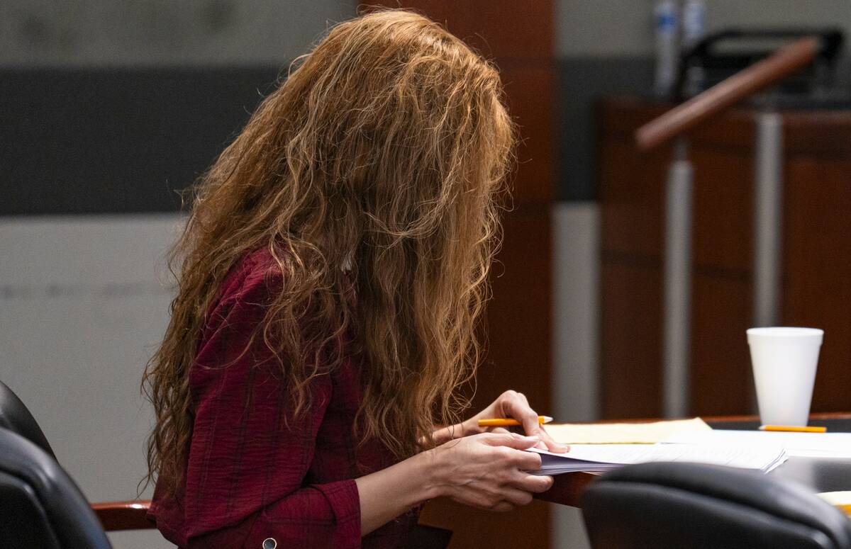 Devyn Michaels looks down during her trial in the killing and decapitation of her on-and-off bo ...
