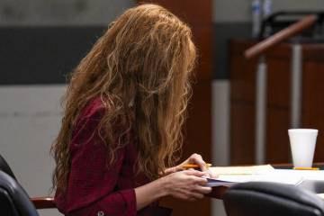 Devyn Michaels looks down during her trial in the killing and decapitation of her on-and-off bo ...