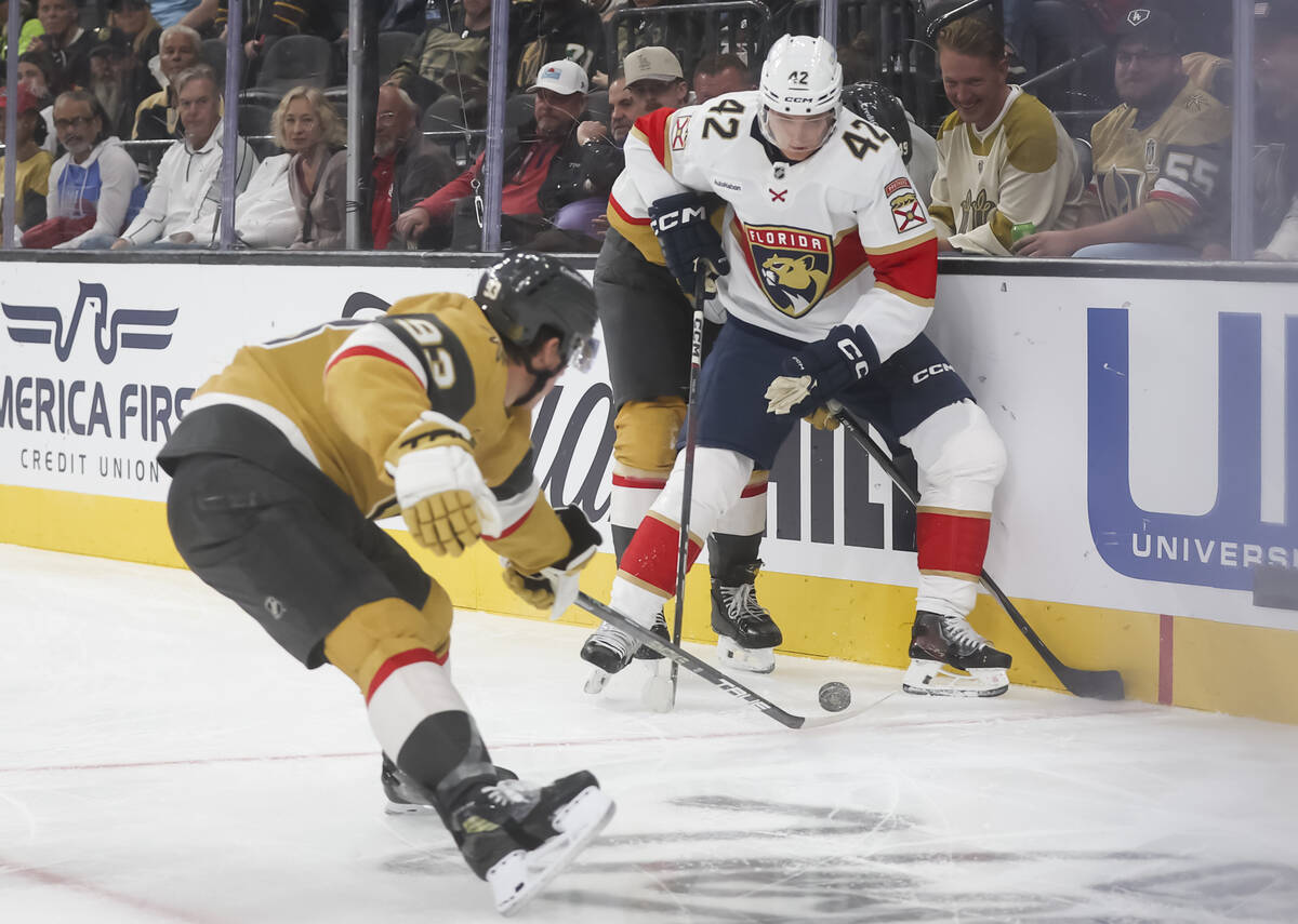 Golden Knights right wing Mitch Marner (93) poke checks the puck against Florida Panthers defen ...