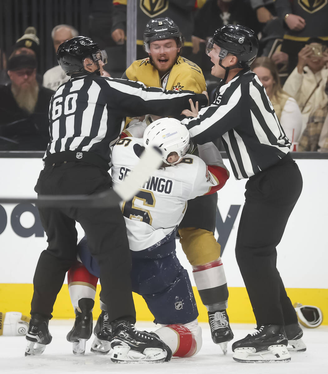Golden Knights defenseman Jeremy Lauzon (5) fights Florida Panthers defenseman Donovan Sebrango ...