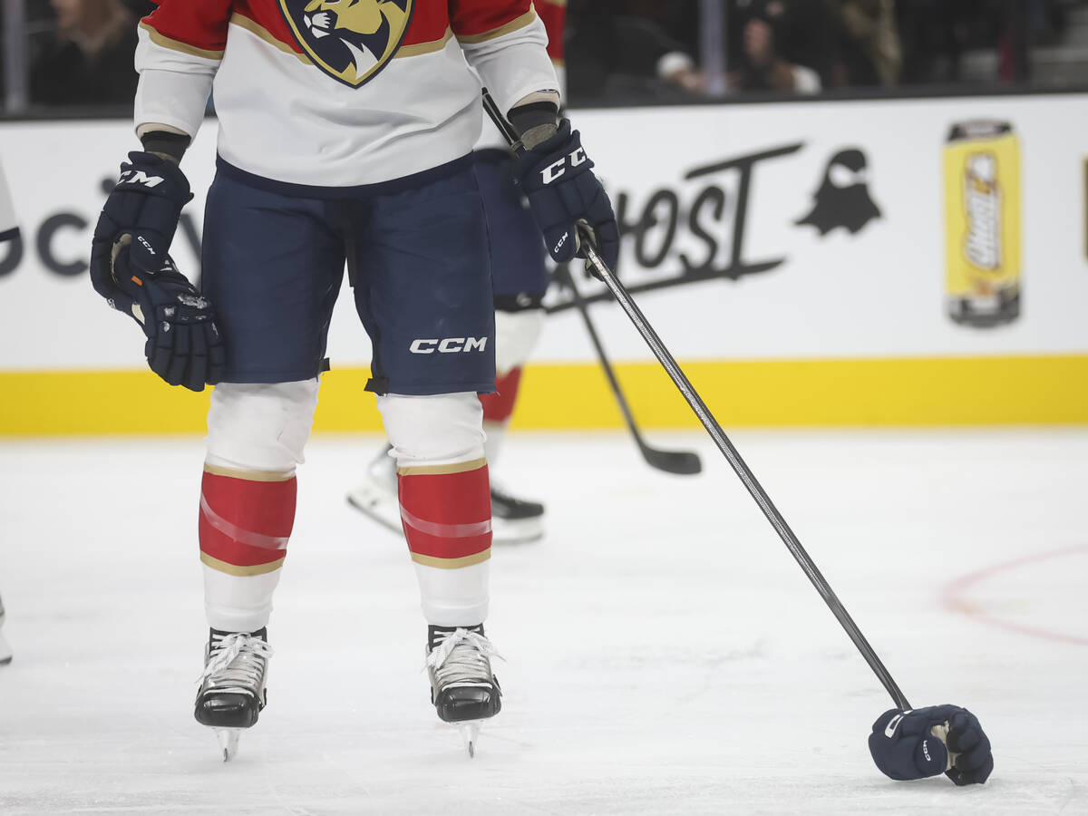 Florida Panthers defenseman Jeff Petry (2) picks up the gloves of Florida Panthers defenseman D ...