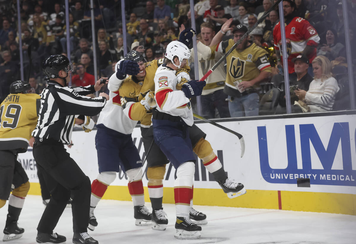 Golden Knights center Brett Howden (21) fights Florida Panthers defenseman Niko Mikkola (77) du ...