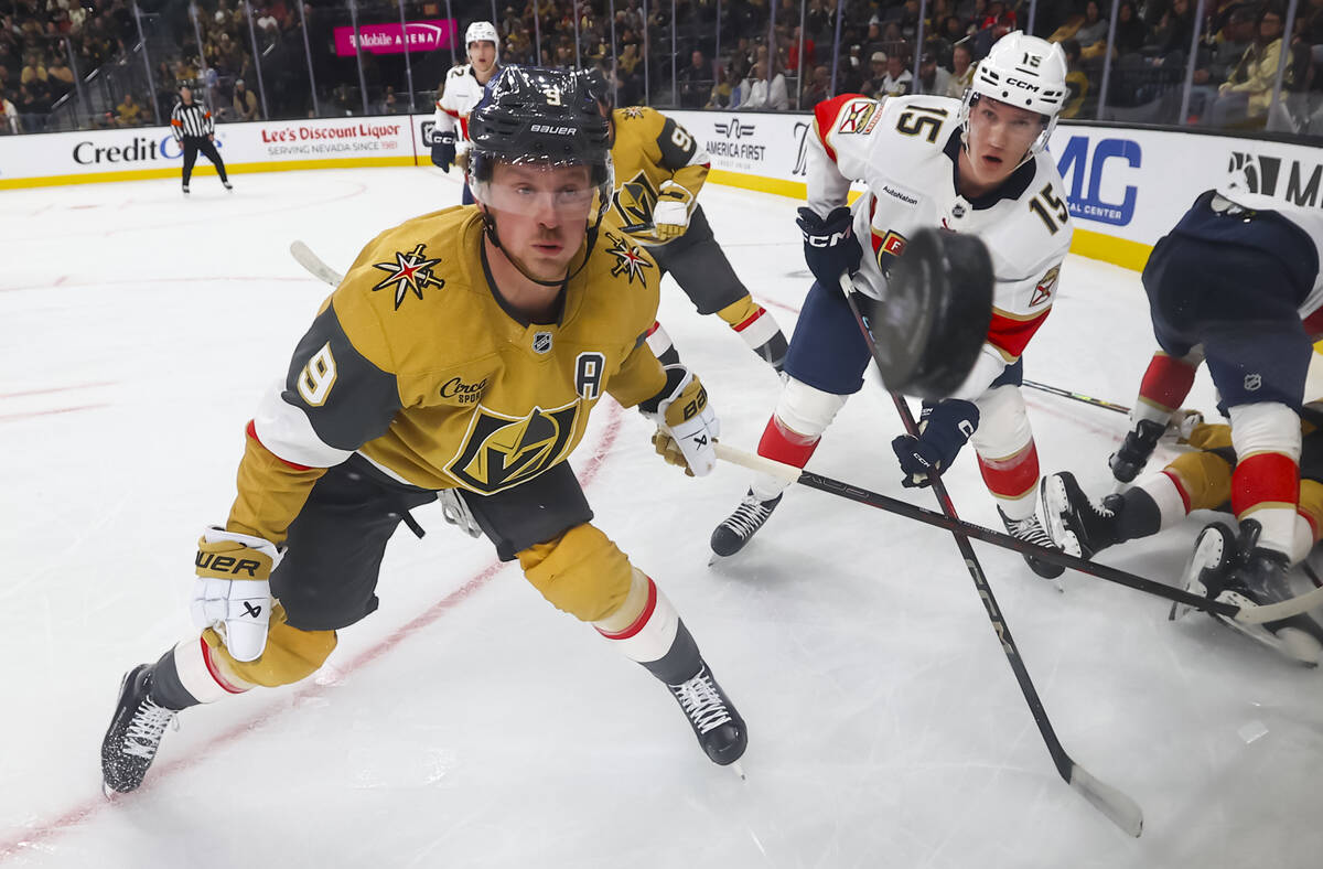 Golden Knights center Jack Eichel (9) and Florida Panthers center Anton Lundell (15) eye the pu ...