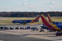 A Southwest Airlines plane taxis down the runway as others sit at gates at Baltimore/Washington ...